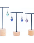 Angelco Accessories Ceramic bead cork drop earrings in green, blue and purple, presented on stands