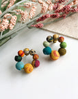 Angelco Accessories kantha ring studs on white flatlay with pink floral background