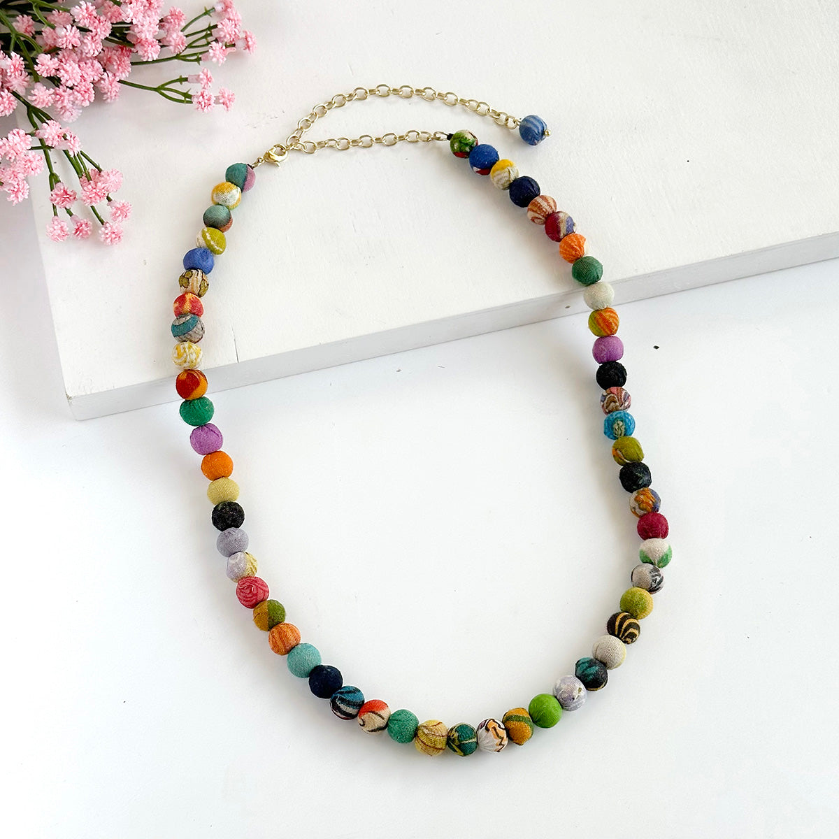 Angelco Accessories single strand kantha short necklace with pink flowers in background