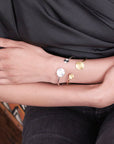 Angelco Accessories hammered coin cuffs - gold and silver cuff worn by model