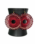 Angelco Accessories colour burst circle earrings hanging on ceramic cup on white background - red