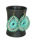 Angelco Accessories Colour burst teardrop earrings hanging on ceramic cup on white background - mint