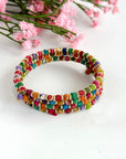 Angelco Accessories mini kantha bead bangle displayed with pink flowers in background