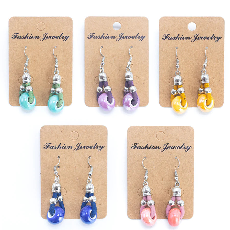 Angelco Accessories Ceramic bead cork drop earrings in all colours , presented on cardboard cards on white flatlay