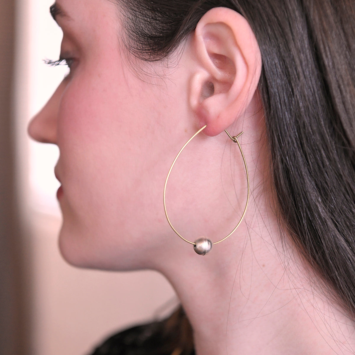 Angelco Accessories Floating pearl hoop earrings  - close up as worn by model