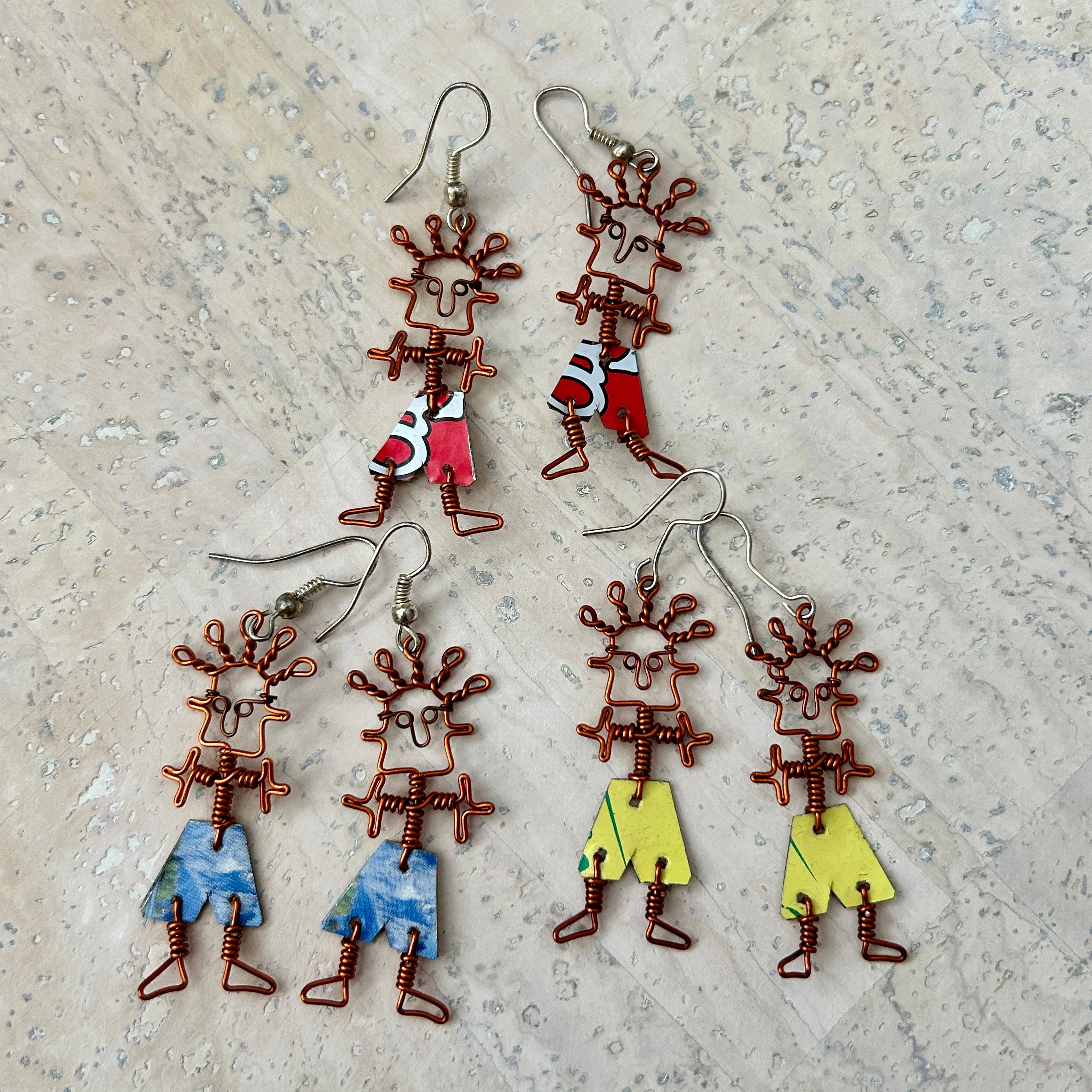 Angelco Accessories Dancing people earrings - an assortment of colours on a white cork background