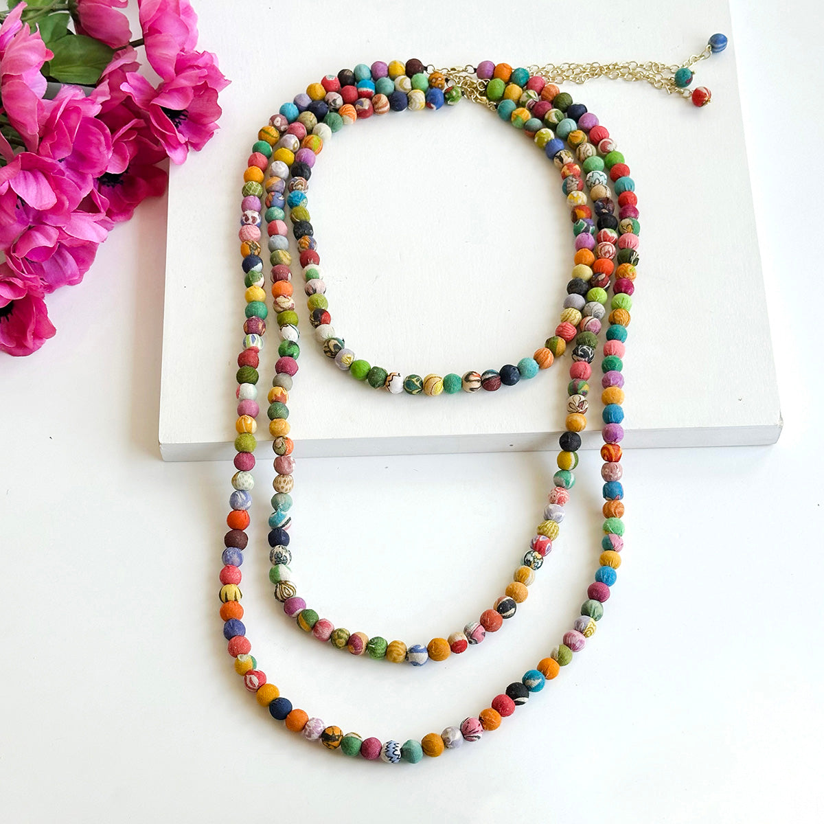 Angelco Accessories single strand kantha medium necklace on white flatlay with necklaces of other lengths