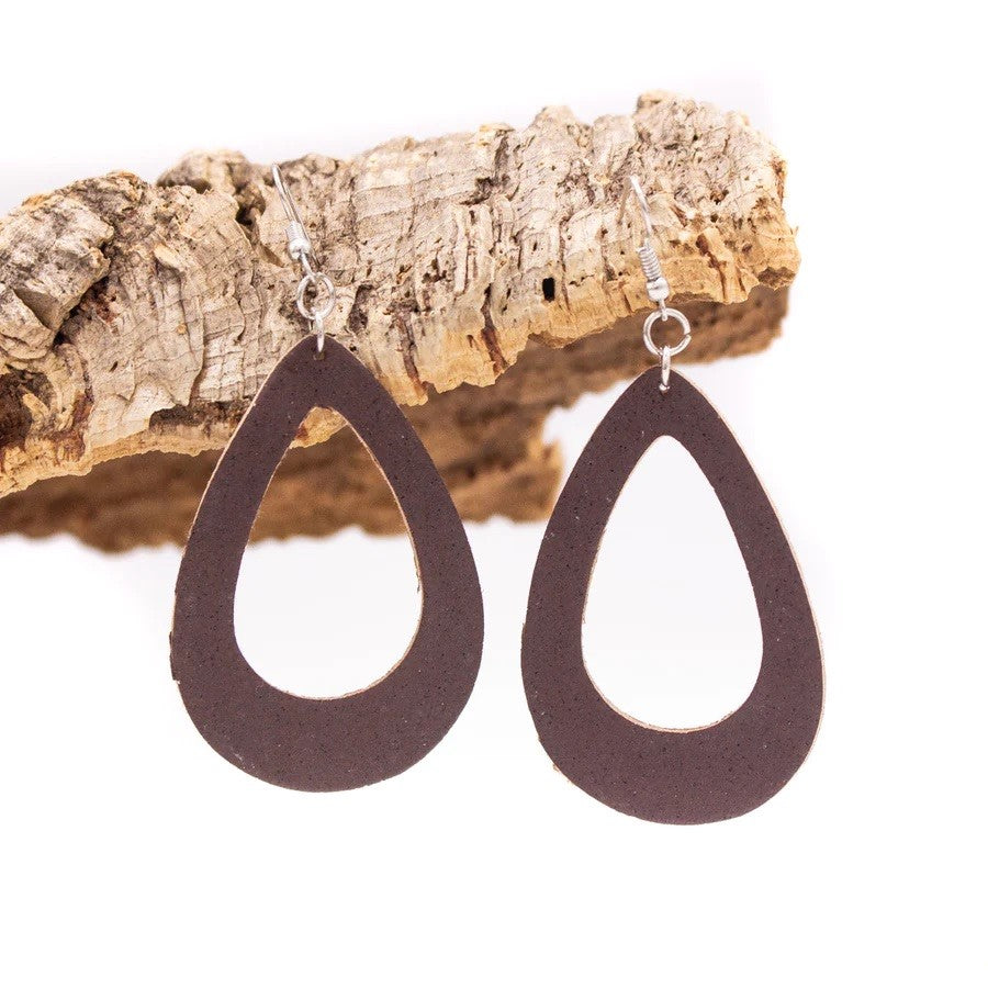Open teardrop dark brown cork drop earrings hanging on cork piece