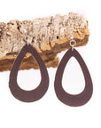 Open teardrop dark brown cork drop earrings hanging on cork piece