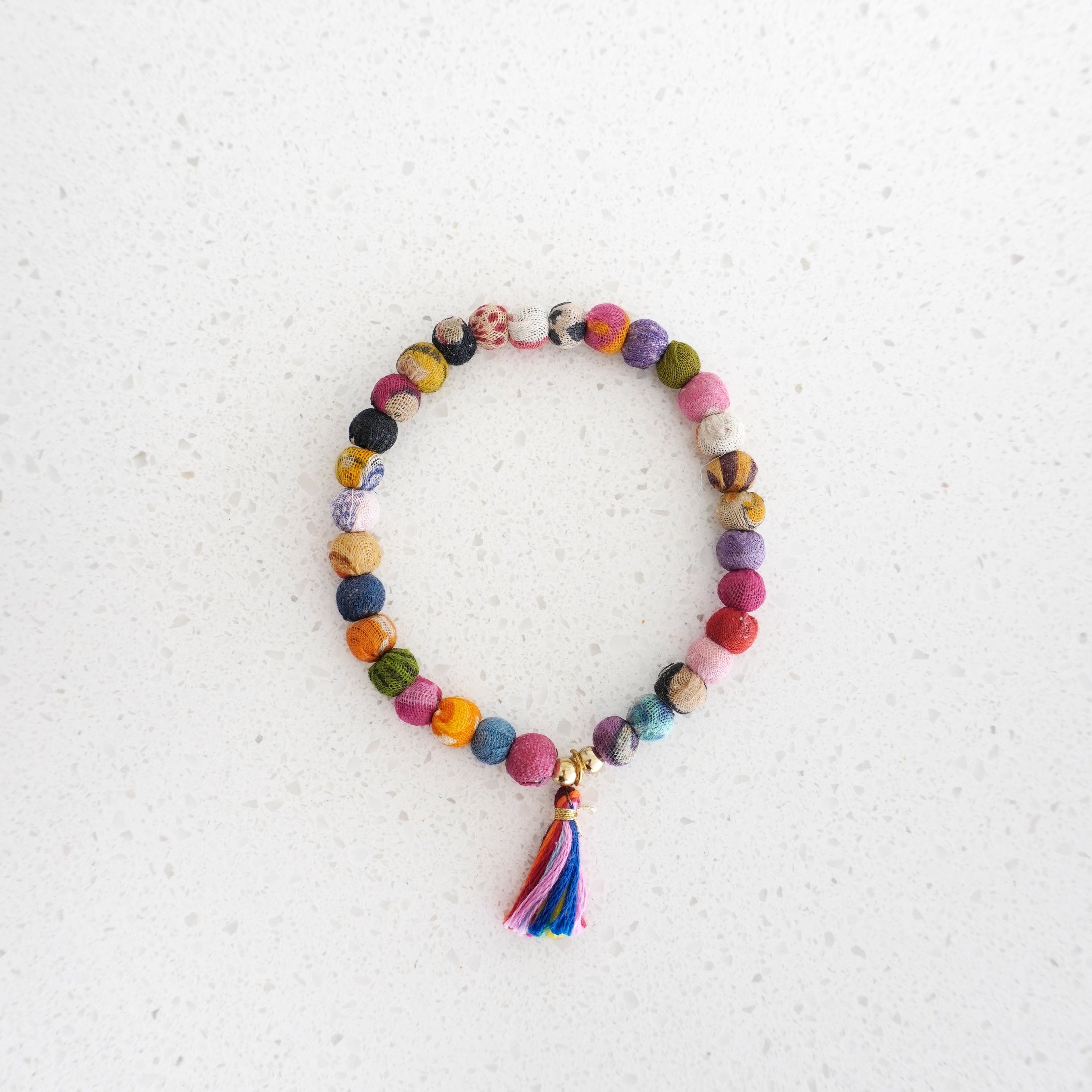 Angelco Accessories Tasseled kantha bracelet  on marble flatlay