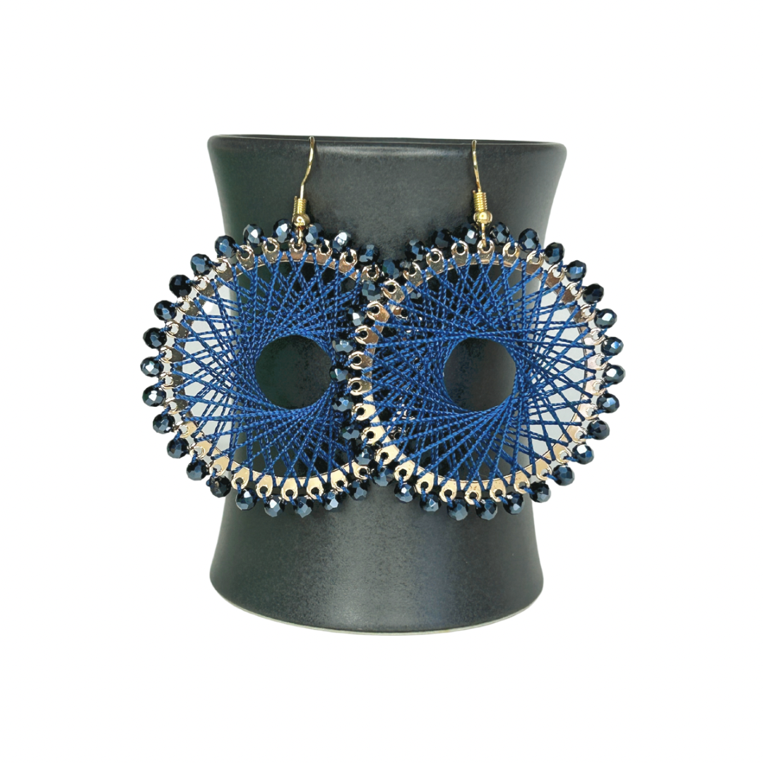 Angelco Accessories Colour burst circle earrings hanging on ceramic cup on white background - indigo