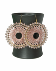 Angelco Accessories Colour burst circle earrings hanging on ceramic cup on white background - rose