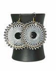 Angelco Accessories Colour burst circle earrings hanging on ceramic cup on white background - silver