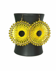 Angelco Accessories Colour burst circle earrings hanging on ceramic cup on white background - yellow