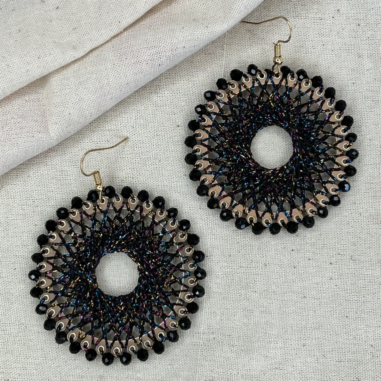 Angelco Accessories colour burst circle earrings on linen background - black colourful