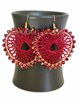 Angelco Accessories Colour burst heart earrings hanging on ceramic cup on white background - red
