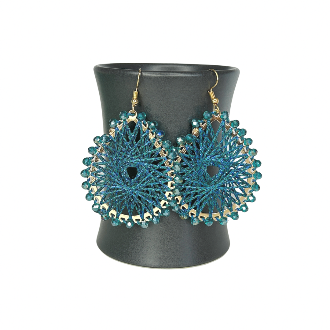 Angelco Accessories Colour burst teardrop earrings hanging on ceramic cup on white background - teal